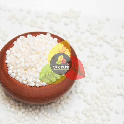 Terracotta bowl filled with white pearls on a white background with 'Spices.Pk' label.