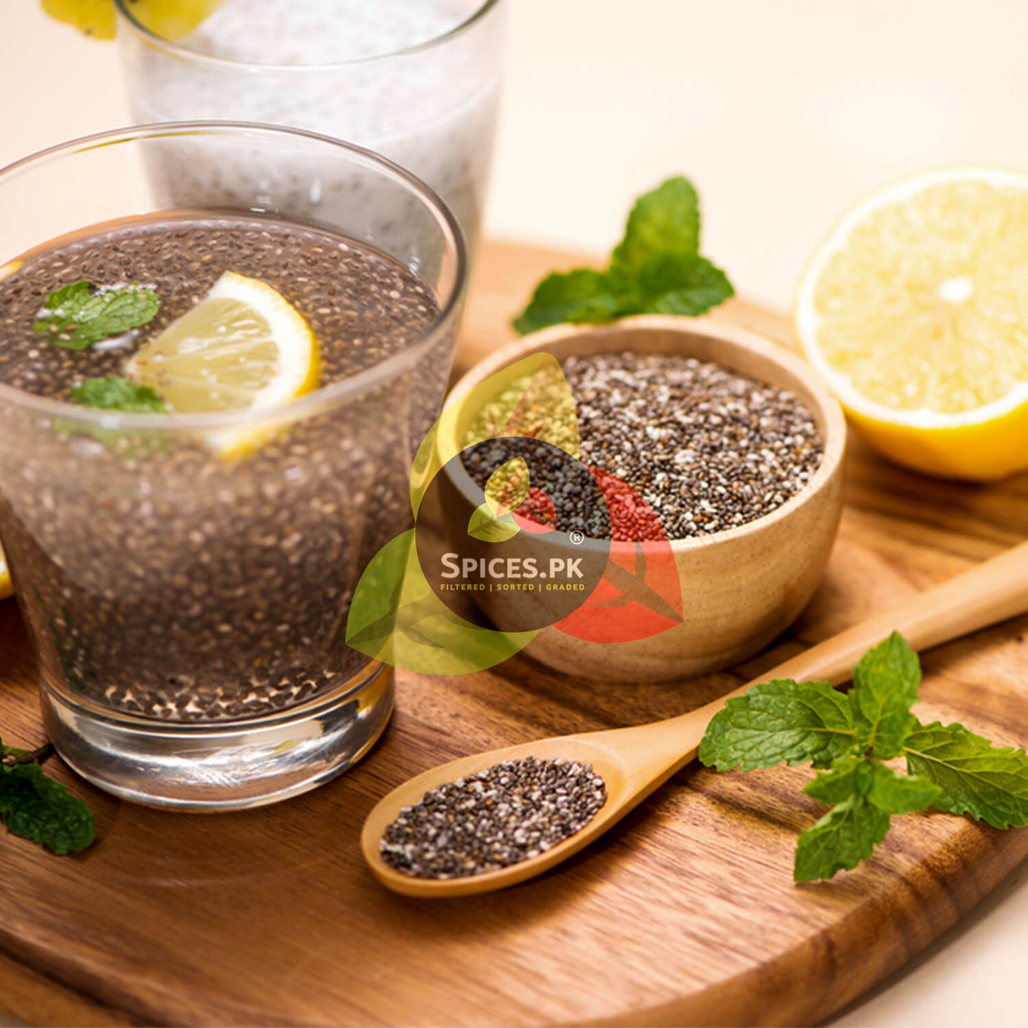 Healthy chia seed drink with lemon and mint in a glass, served with raw organic seeds for a keto-friendly diet.