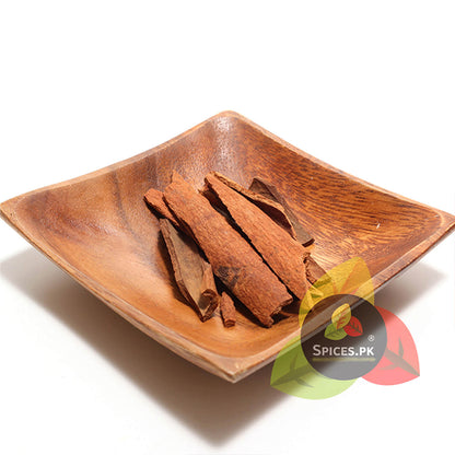 Premium whole cinnamon sticks (Dalchini) in a wooden bowl—natural aromatic spice for cooking and tea.