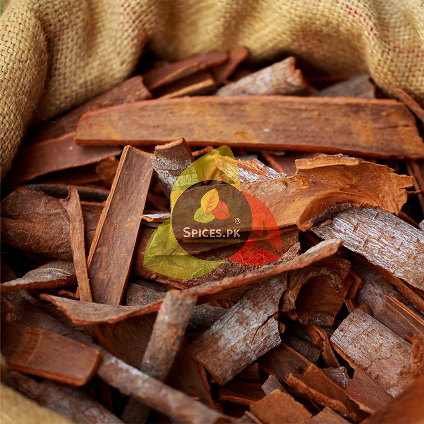 Close-up of high-quality, graded cinnamon bark sticks in a burlap sack from Spices.pk.
