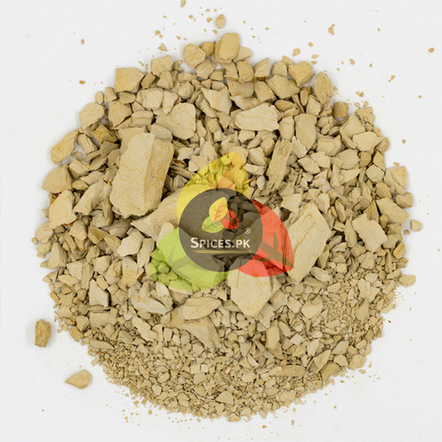 Top view of crushed Multani Mitti mud mask stones and granulated pieces layered evenly on a white surface.