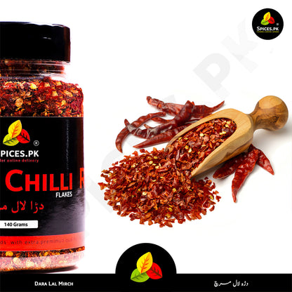 Dara Lal Mirch (Crushed Red Chilli) displayed on a wooden scoop with whole dried peppers for authenticity – Spices.pk.