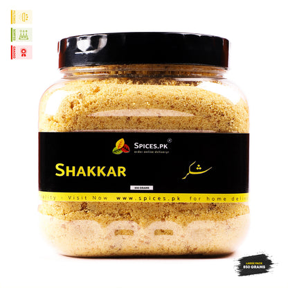 Jar of 'Shakkar' (sugar) from Spices.Pk on a white background.Front view of Spices.pk Desi Shakkar 850 grams jar, a premium quality unrefined jaggery powder in Pakistan.