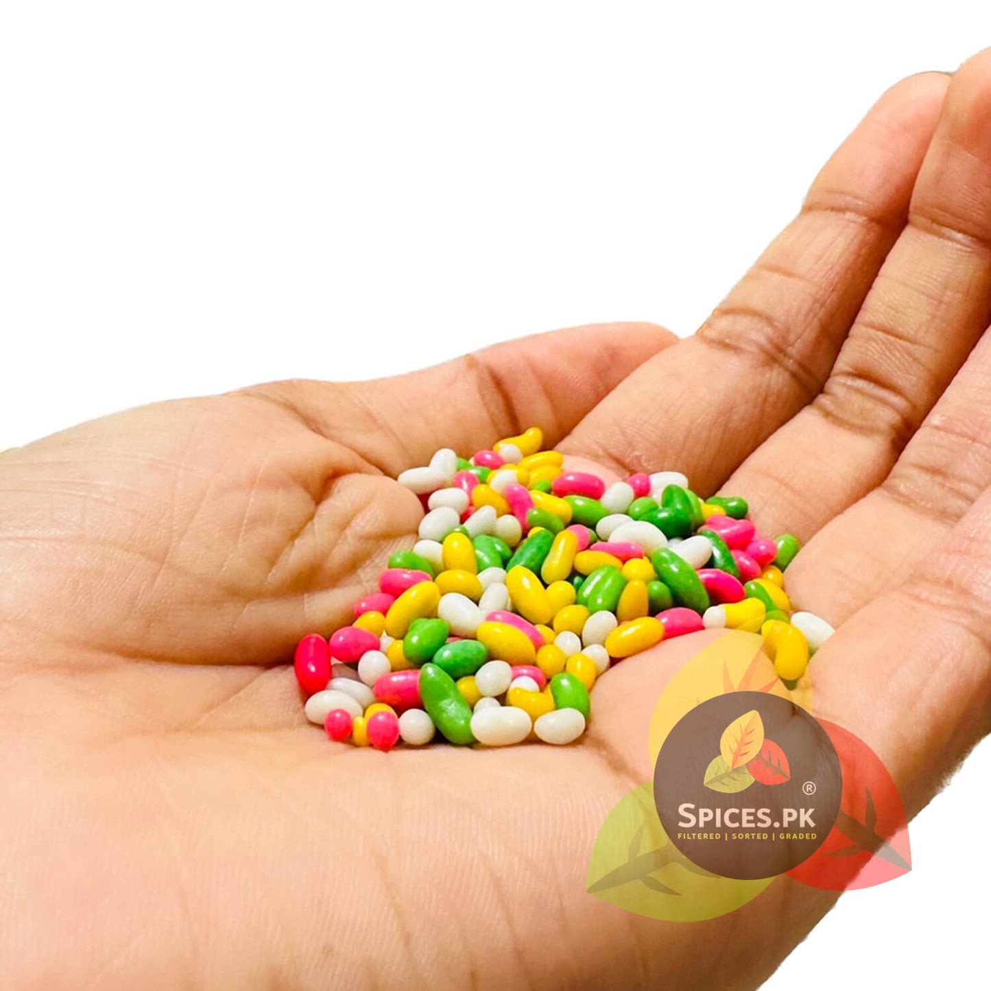 A handful of colorful sugar coated fennel seeds (Meethi Saunf) showing the premium size and bright colors of Spices.pk sweet pack.