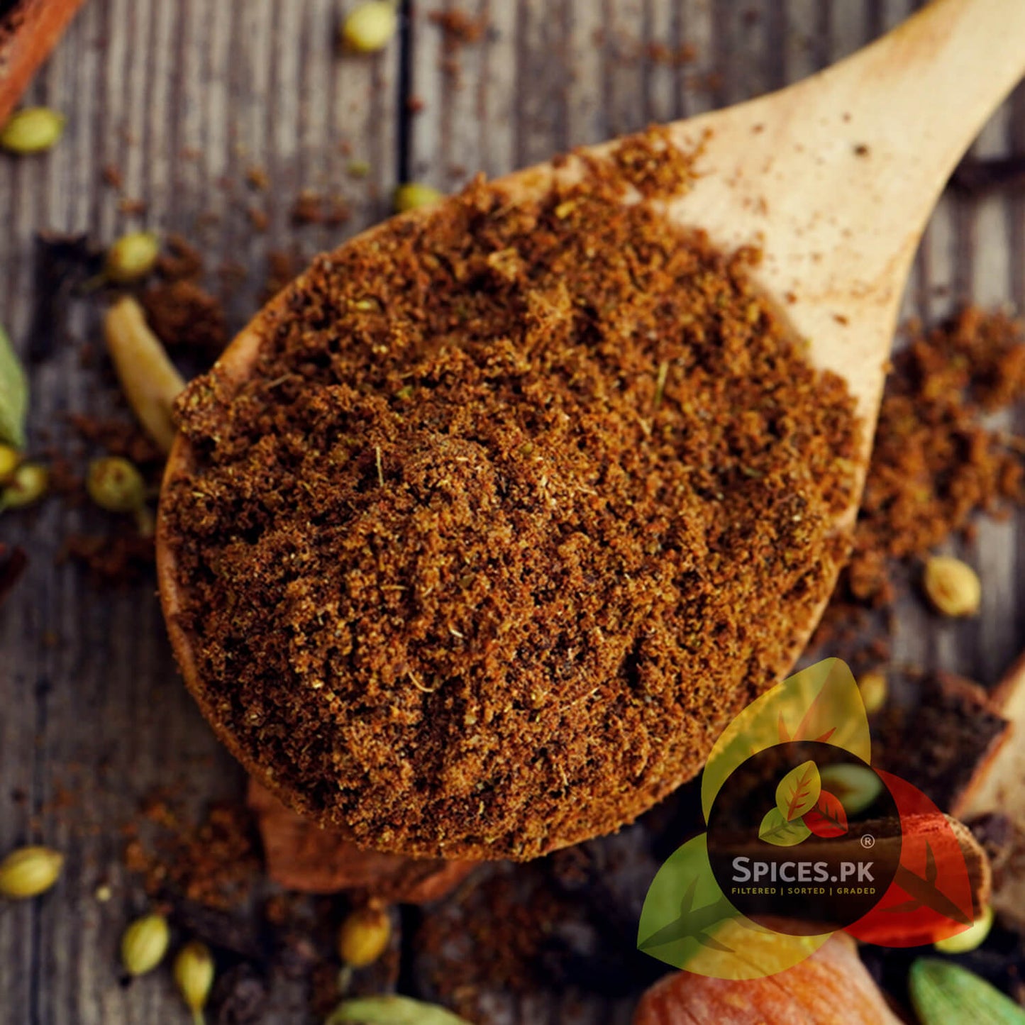 A wooden spoon filled with authentic Garam Masala Powder, emphasizing the natural earthy tones and potent aroma of Spices.pk's unique spice blend. Ideal for professional and home cooking.