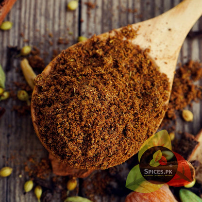A wooden spoon filled with authentic Garam Masala Powder, emphasizing the natural earthy tones and potent aroma of Spices.pk's unique spice blend. Ideal for professional and home cooking.