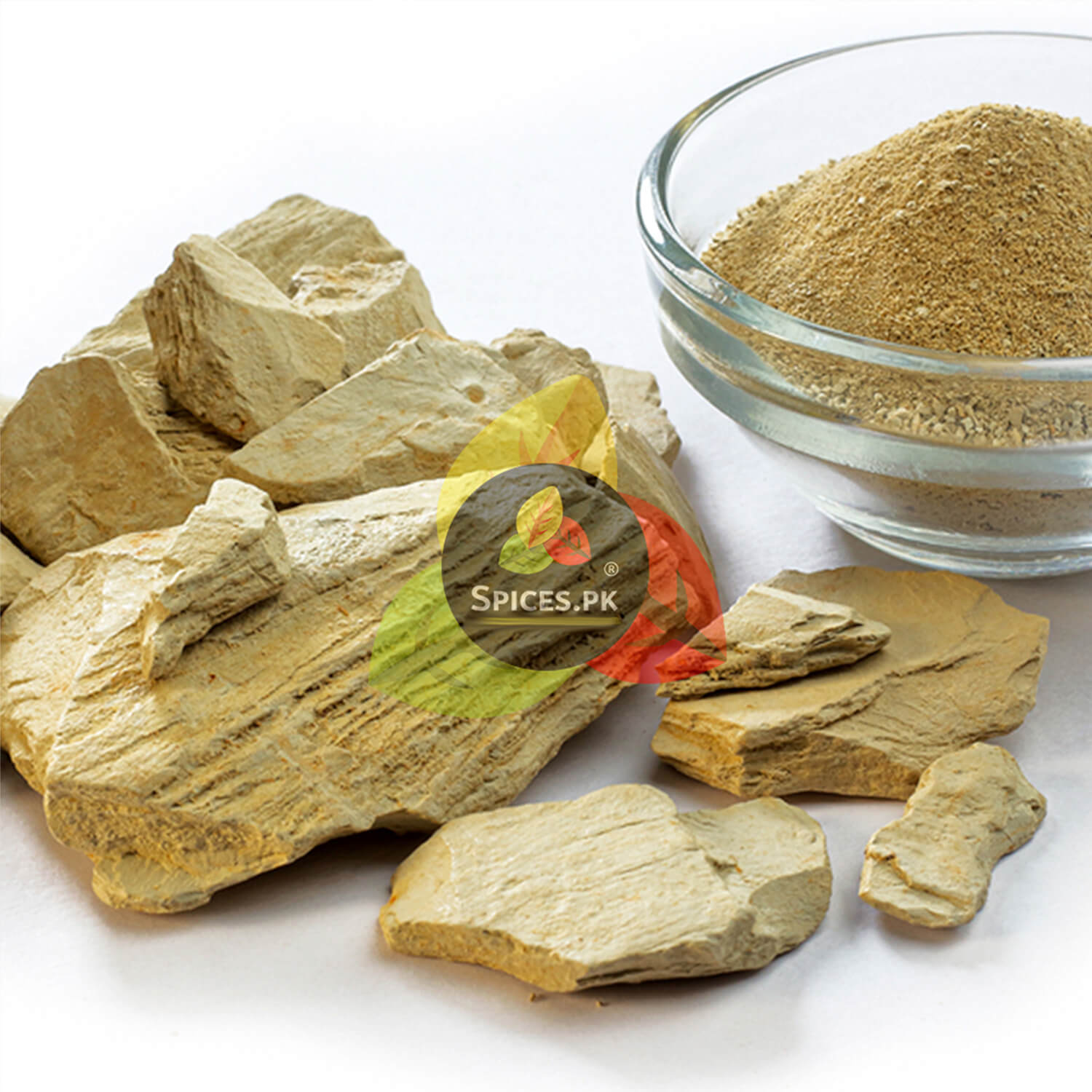 Pure Multani Mitti stones placed next to fine Fuller's earth powder in a clear glass bowl for face mask preparation.