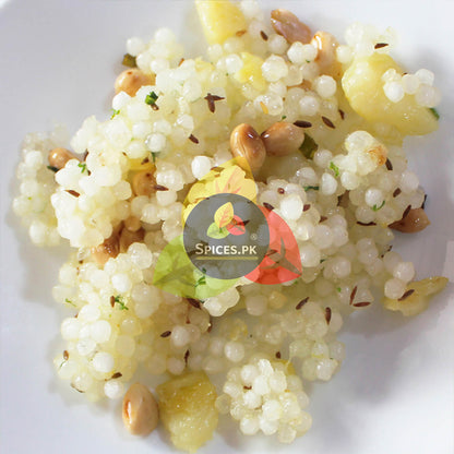 Couscous dish with nuts and vegetables on a white plate, branded with 'Spices.PK'.