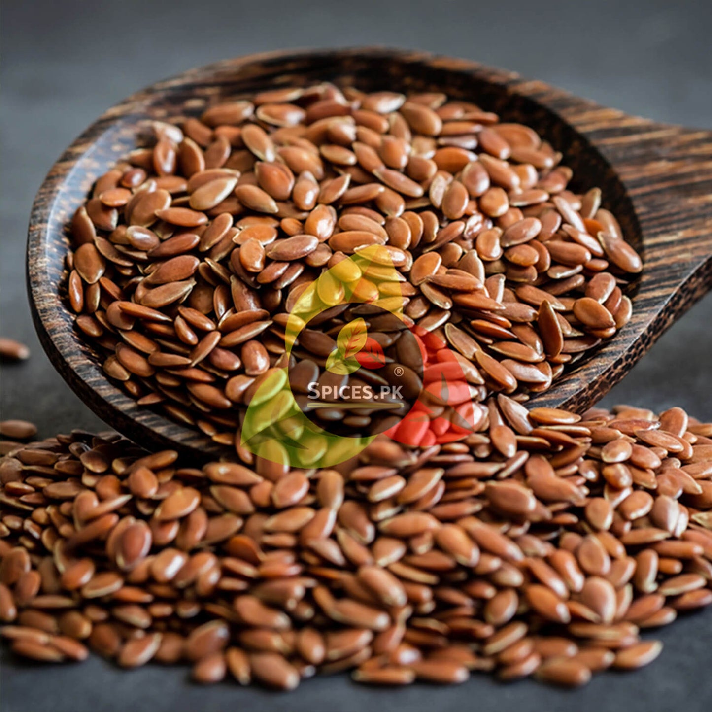 High-quality, sorted, and graded alsi (flax seeds) by Spices.pk. 100% natural, no preservatives, and completely dust-filtered.Wooden bowl filled with brown flaxseeds on a dark surface, with 'Spices.PK' logo.
