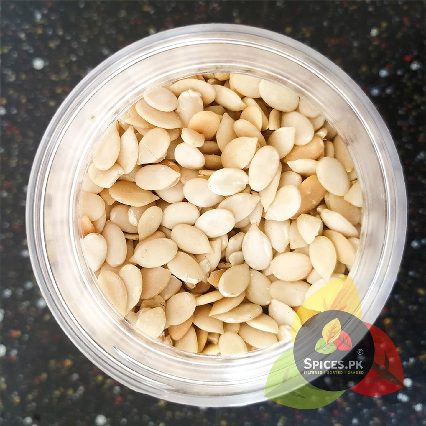 Close-up top-down view of clean, peeled, and graded premium Char Maghaz melon seeds inside a Spices.pk container.