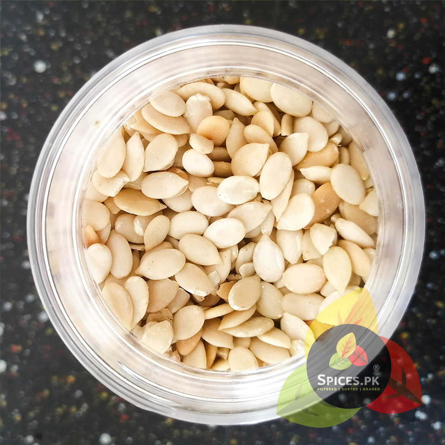 Close-up top-down view of clean, peeled, and graded premium Char Maghaz melon seeds inside a Spices.pk container.