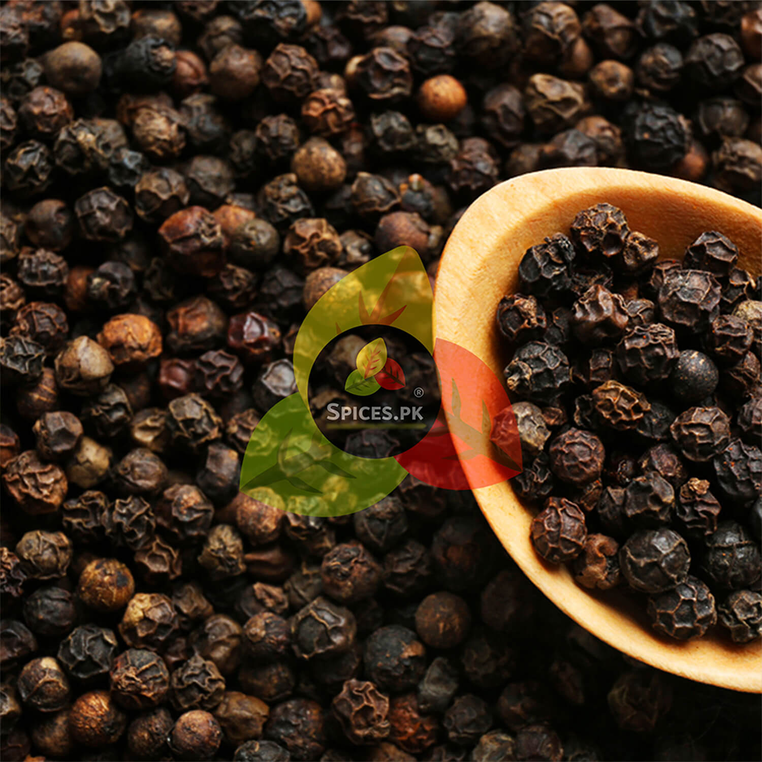 Close-up of whole Black Pepper Corns being poured from a 170g jar into a wooden scoop, showcasing freshness and texture.