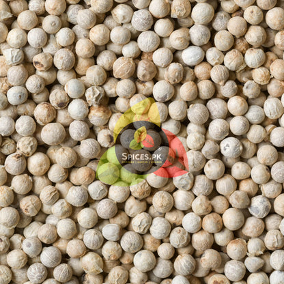 Macro flat lay texture of clean, round white pepper whole seeds showcasing Spices.pk premium dakhni mirch quality.
