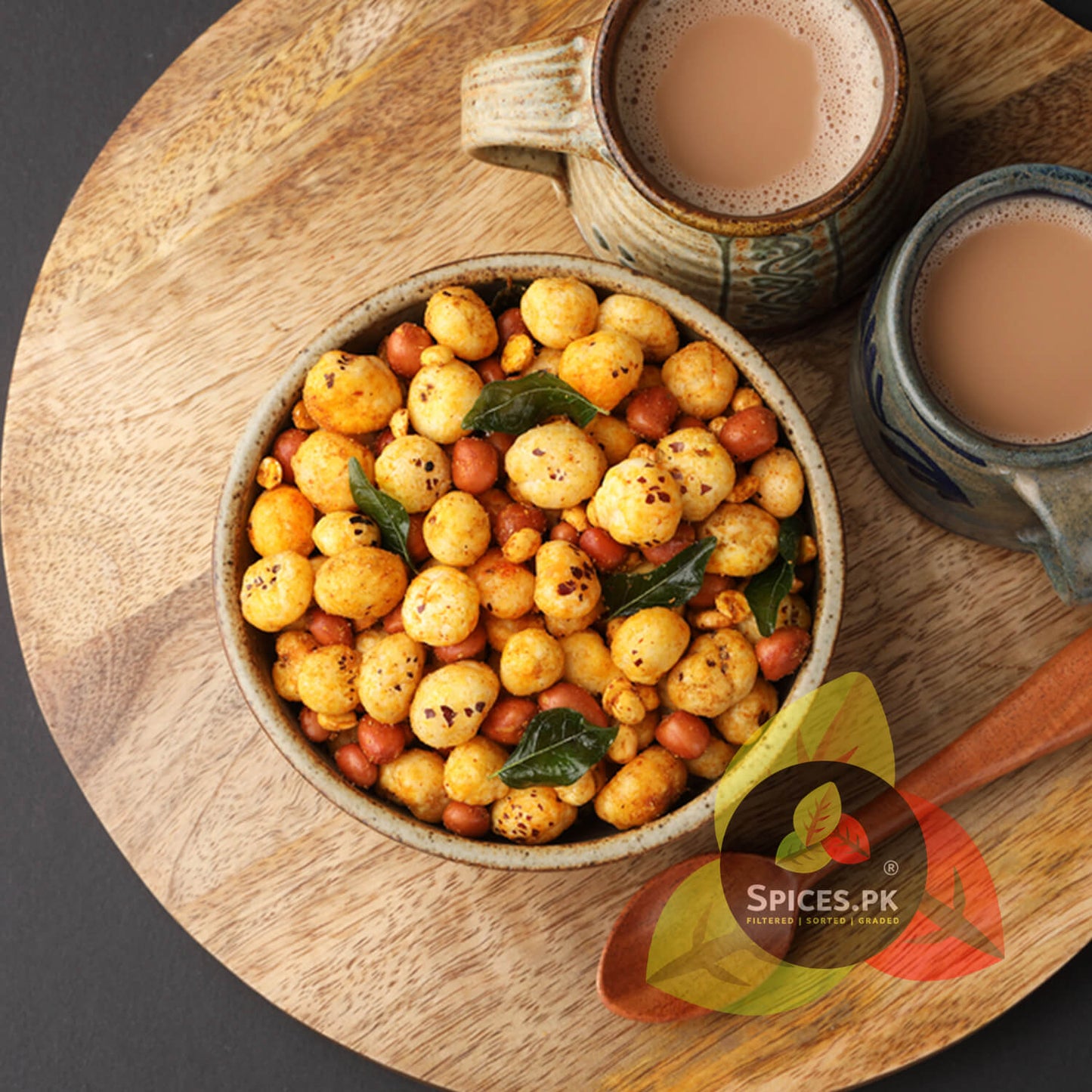 Bowl of roasted chickpeas with a cup of tea on a wooden board, featuring the Spices.PK logo.Top-grade pure desi phool makhana (پھول مکھانہ) available for online delivery across Pakistan from Spices.pk.