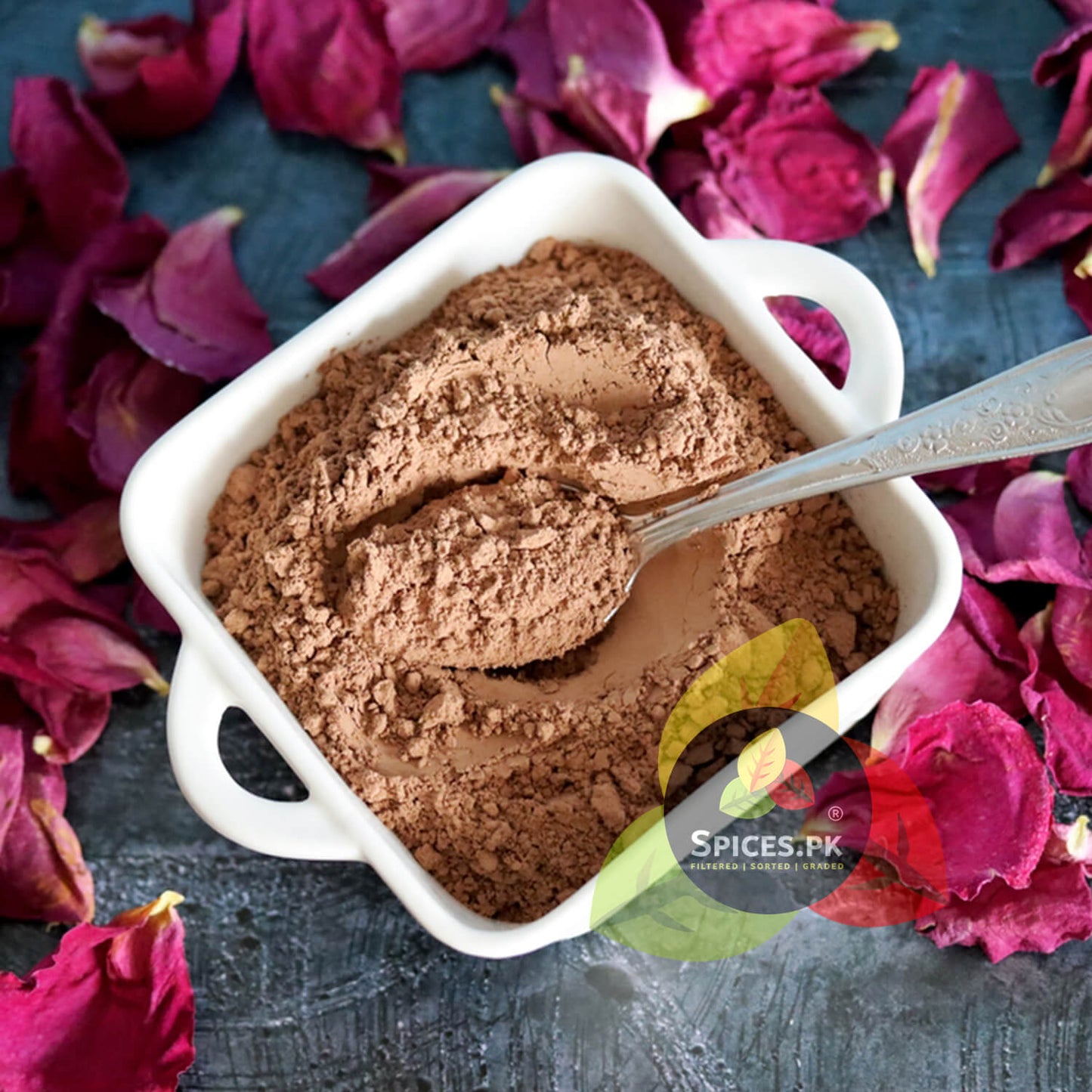 Close-up texture of finely filtered organic rose petal powder for face masks, showing its natural pink tint.