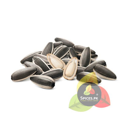 A small pile of striped raw sunflower seeds with one seed peeled open to reveal the natural edible white kernel inside.Sunflower seeds on a white background with 'Spices.PK' logo.
