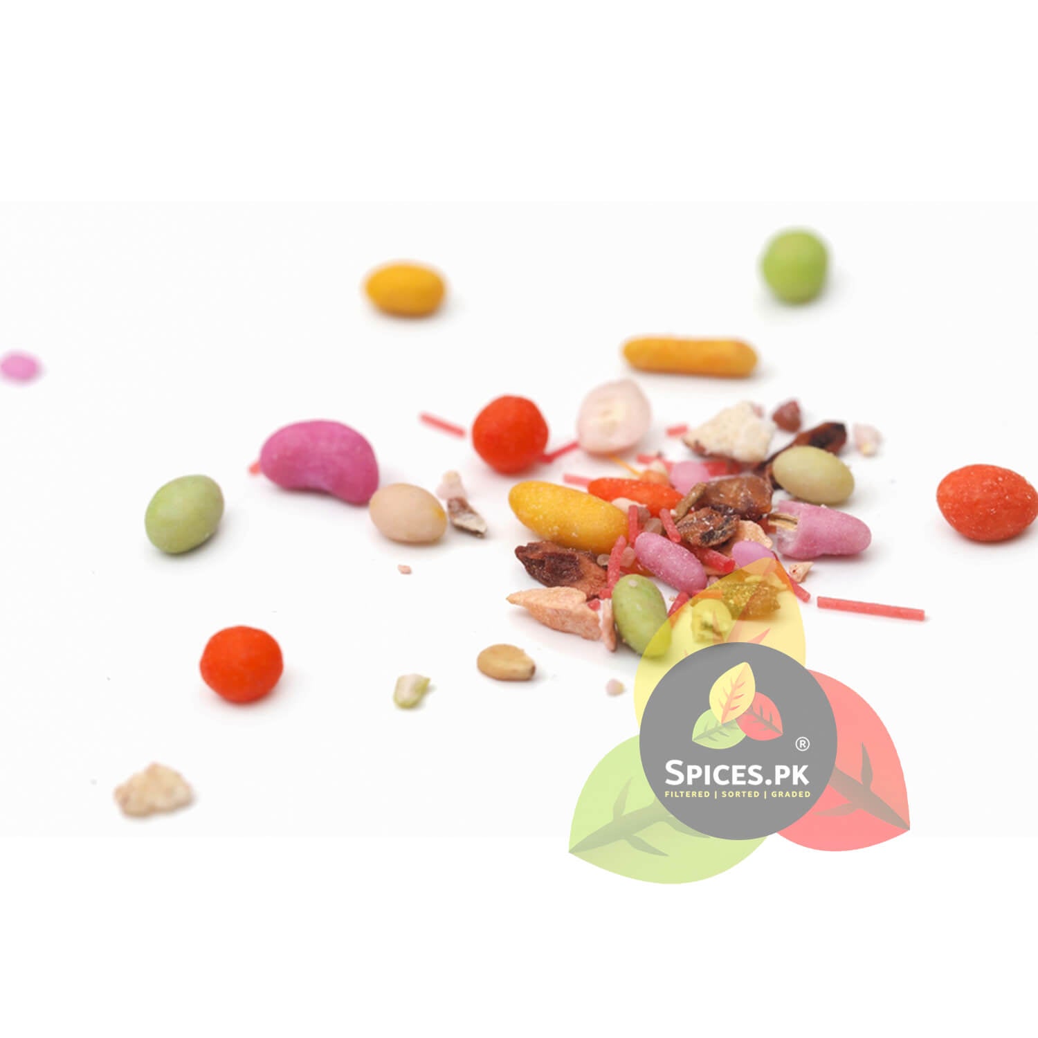 Scattered view of meetha pan masala candy seeds, chocolate dana, and aromatic sweet saunf mouth freshener by Spices.pk.