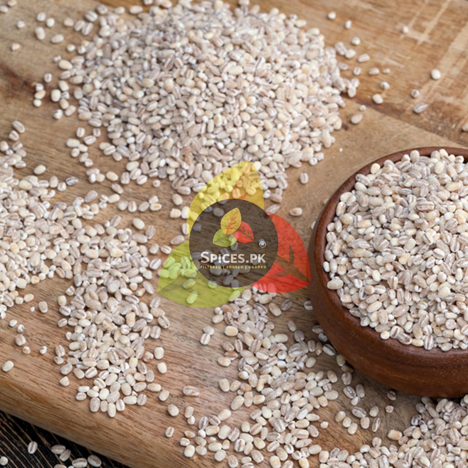 Premium raw whole barley seeds scattered on a wooden cutting board showing the natural source of jau ka daliya.