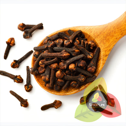 Close-up of premium whole spice cloves scattered across a white background, displaying their unbroken heads and premium grading.